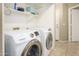 A laundry room featuring a side-by-side Samsung washer and dryer set and shelving at 8331 E Plata Ave, Mesa, AZ 85212
