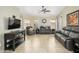 Bright living room features neutral tones, tile floors, ceiling fan and plenty of space for relaxing and entertaining at 8331 E Plata Ave, Mesa, AZ 85212