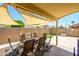 Covered outdoor patio with dining set, offering shade and a relaxing space for entertaining and enjoying the outdoors at 8331 E Plata Ave, Mesa, AZ 85212