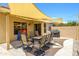 Inviting backyard patio with sunshade, dining table, and grill for outdoor entertaining at 8331 E Plata Ave, Mesa, AZ 85212
