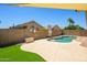 Relaxing backyard pool area with artificial turf and secure brick fence at 8331 E Plata Ave, Mesa, AZ 85212