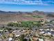 Scenic aerial view of a residential neighborhood with golf course access, framed by desert landscape and distant mountain views at 856 E Village Cir S Dr, Phoenix, AZ 85022