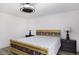 Comfortable bedroom with a wooden bed frame and matching nightstands and stylish ceiling fan at 856 E Village Cir S Dr, Phoenix, AZ 85022