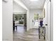 Bright hallway with wood-look tile flooring, a skylight, and views of the front yard at 856 E Village Cir S Dr, Phoenix, AZ 85022