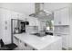Bright kitchen featuring stainless steel appliances, a quartz countertop island, and modern tile backsplash at 856 E Village Cir S Dr, Phoenix, AZ 85022