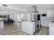 Open kitchen and dining area with white cabinetry, an island, and modern light fixtures at 856 E Village Cir S Dr, Phoenix, AZ 85022