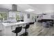 Open kitchen and living room concept with white cabinetry and skylight, fostering a bright, airy atmosphere at 856 E Village Cir S Dr, Phoenix, AZ 85022