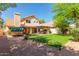 Expansive backyard showcasing a barrel sauna, covered patio, and well-manicured lawn at 8845 E Larkspur Dr, Scottsdale, AZ 85260
