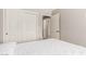 Minimalist bedroom with white walls, double closets, and natural light creates a serene atmosphere at 8845 E Larkspur Dr, Scottsdale, AZ 85260