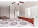 Bedroom featuring wooden bed frame, comfortable seating, ceiling fan, and access to ensuite bath and closets at 8845 E Larkspur Dr, Scottsdale, AZ 85260