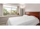 Bedroom with a large window, comfortable bed, and a teddy bear adding a touch of homeliness at 8845 E Larkspur Dr, Scottsdale, AZ 85260