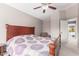 Bedroom showcasing a wooden bed frame with patterned bedding, ceiling fan, and comfortable sitting area at 8845 E Larkspur Dr, Scottsdale, AZ 85260
