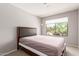 Bedroom features a large window with neighborhood views and a minimalist design at 8845 E Larkspur Dr, Scottsdale, AZ 85260