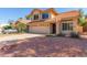 Charming two-story home featuring a desert landscape and a welcoming two car garage at 8845 E Larkspur Dr, Scottsdale, AZ 85260