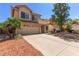 Beautiful two-story home featuring a two-car garage and desert landscape at 8845 E Larkspur Dr, Scottsdale, AZ 85260