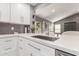 Modern kitchen featuring white cabinets, quartz countertop, and stainless-steel sink at 8845 E Larkspur Dr, Scottsdale, AZ 85260