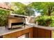 Outdoor kitchen with built-in grill and ample countertop space at 8845 E Larkspur Dr, Scottsdale, AZ 85260