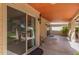 Covered outdoor patio featuring a tile roof, lights, and access to the backyard at 8845 E Larkspur Dr, Scottsdale, AZ 85260