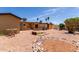 Spacious backyard featuring a desert landscape, defined planters, and mature trees adding character at 962 S Main Dr, Apache Junction, AZ 85120