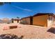 Backyard with xeriscape landscape, including desert plants, rock accents, and patio at 962 S Main Dr, Apache Junction, AZ 85120