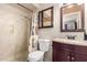 Standard full bathroom with a shower-tub combination, toilet, mirrored medicine cabinet and dark vanity at 962 S Main Dr, Apache Junction, AZ 85120