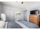Bedroom with neutral walls, closet, television, and sliding door access to a room with a double bed at 962 S Main Dr, Apache Junction, AZ 85120