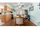 Bright dining area with blue walls, hardwood floors, a ceiling fan, and a view to the backyard at 962 S Main Dr, Apache Junction, AZ 85120