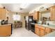 Bright kitchen featuring tile floors, wooden cabinets, stainless steel refrigerator, and decorative wall art at 962 S Main Dr, Apache Junction, AZ 85120