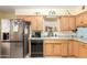 Kitchen featuring wooden cabinets, stainless steel appliances, and ample counter space at 962 S Main Dr, Apache Junction, AZ 85120