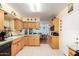 Kitchen with wooden cabinets, tile flooring, and a view of the dining area at 962 S Main Dr, Apache Junction, AZ 85120