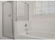 Bathtub and shower combo showcasing modern fixtures and a glass enclosure at 11983 W Fillmore St, Avondale, AZ 85323