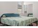 Bright bedroom with a leaf-patterned bedspread, a window, and a mirrored closet at 11983 W Fillmore St, Avondale, AZ 85323