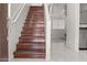 Inviting entryway showcases hardwood stairs with white risers, leading to the upper level at 11983 W Fillmore St, Avondale, AZ 85323