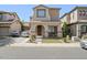 Charming two-story home features a stucco facade, a tiled roof, and a well-manicured front yard at 11983 W Fillmore St, Avondale, AZ 85323