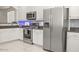 Modern kitchen features stainless steel appliances, white cabinetry, and granite countertops at 11983 W Fillmore St, Avondale, AZ 85323
