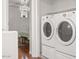 Laundry area featuring front-load washer and dryer with view into bedroom at 11983 W Fillmore St, Avondale, AZ 85323