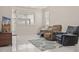 Cozy living room with comfortable seating, a TV, and a patterned rug on marble floors at 11983 W Fillmore St, Avondale, AZ 85323