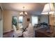 Inviting dining room with a glass table, stylish chairs, chandelier, and access to the outdoor patio at 1302 E Nicolet Ave, Phoenix, AZ 85020