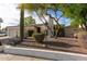 Inviting single-story home with desert landscaping, a two-car garage, and mature trees in the front yard at 1302 E Nicolet Ave, Phoenix, AZ 85020