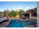 Tranquil backyard featuring a refreshing pool, comfortable sun loungers, outdoor seating, and lush greenery at 1302 E Nicolet Ave, Phoenix, AZ 85020