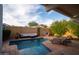 Scenic backyard oasis featuring a pool, sun loungers, outdoor seating, lush greenery, and beautiful blue skies at 1302 E Nicolet Ave, Phoenix, AZ 85020