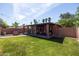 Lush backyard showcasing a covered patio area, outdoor grill, and palm trees perfect for outdoor entertaining at 1546 W Culver St, Phoenix, AZ 85007