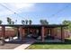 Spacious backyard with a covered patio that includes comfortable seating and string lights, ideal for relaxing or entertaining guests at 1546 W Culver St, Phoenix, AZ 85007