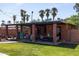 Inviting backyard with a covered patio, outdoor seating, and manicured lawn with mature landscaping, offering a private oasis at 1546 W Culver St, Phoenix, AZ 85007