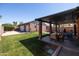 Expansive backyard featuring a covered patio with an outdoor dining area and a two-car garage with a private entrance at 1546 W Culver St, Phoenix, AZ 85007