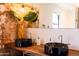 Bathroom boasting dual vessel sinks atop a wooden countertop with a brick wall at 1546 W Culver St, Phoenix, AZ 85007