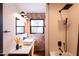 Chic bathroom featuring white tile, exposed brick, modern fixtures, a vessel sink, and a stylish vanity at 1546 W Culver St, Phoenix, AZ 85007