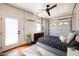 Bedroom in converted garage with polished concrete floors, ceiling fan, and a sliding garage door for an open, airy feel at 1546 W Culver St, Phoenix, AZ 85007
