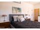 Cozy bedroom with sleek ceiling fan, stylish decor, and modern built-in vanity, offering a comfortable and chic retreat at 1546 W Culver St, Phoenix, AZ 85007