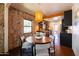 Inviting dining area features exposed brick, modern light fixture, and adjacent kitchen at 1546 W Culver St, Phoenix, AZ 85007
